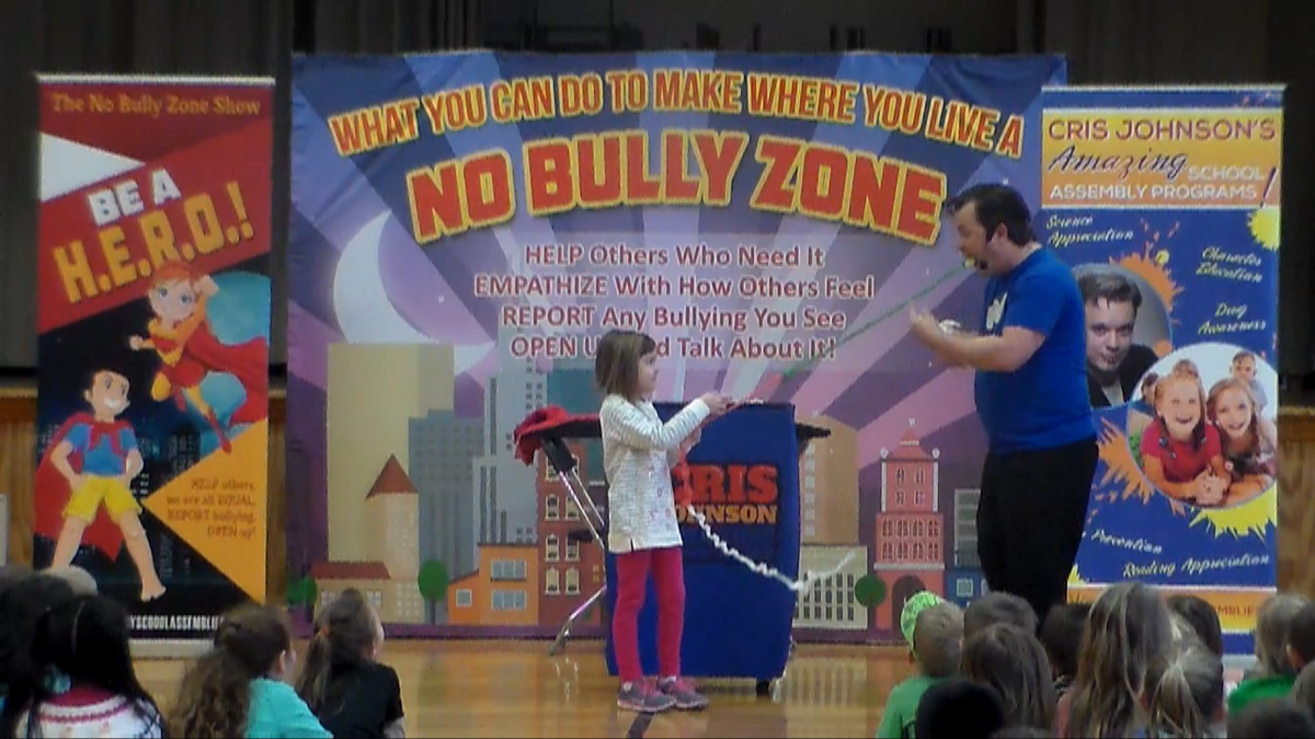 school assembly presenter Cris Johnson at a bully prevention show with 1 volunteer