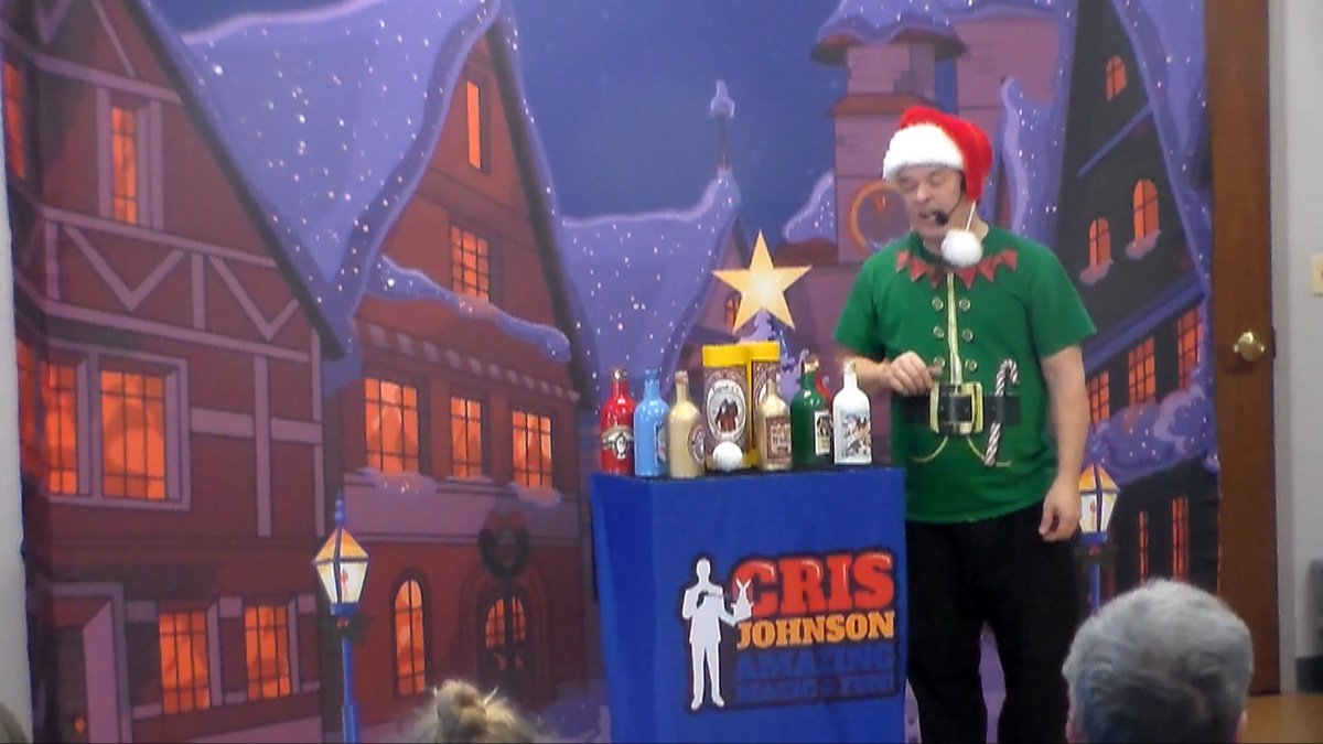 School assembly presenter Cris Johnson performing at a Christmas magic show