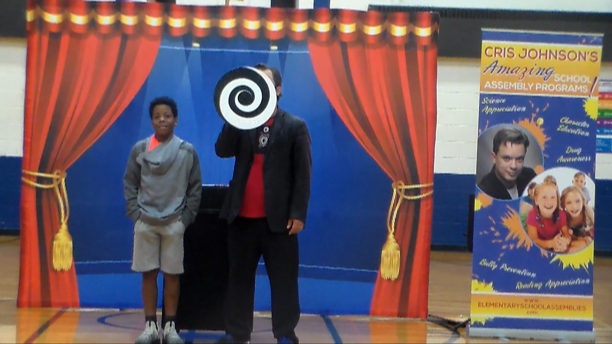 Middle school assembly presenter Cris Johnson with 1 volunteer