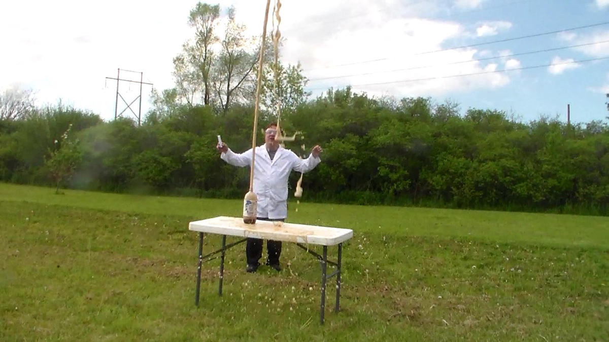 STEM Science School Assemblies performer Cris Johnson performing an outdoor STEM experiment